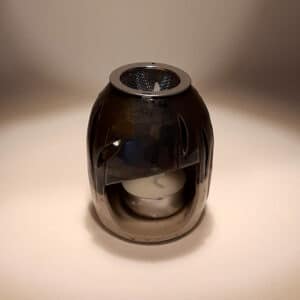 Brule-résine en terre de grés, émaillé bicolore, ivoire et noir, décor de feuille. A l'intérieur se trouve une bougie chauffe-plat et au dessus, une grille permettant de déposer quelques grains de résines. Permet de parfumer un lieu, ou de le nettoyer des mauvaises énergies stagnantes.