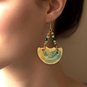 Boucles d'oreilles accompagnées de perles cristal. Forme éventail, monture métal doré.